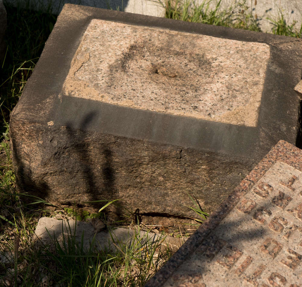 tombstone that has fallen over